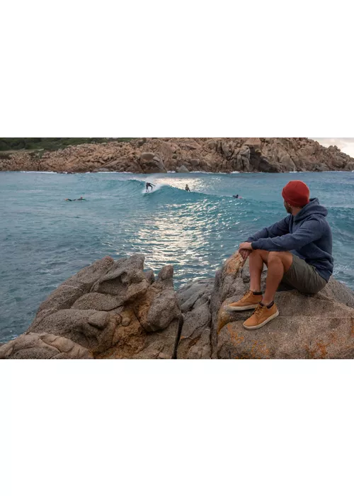 Guy on the rocks in front of the sea