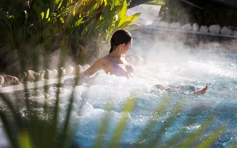 By the pool, enveloped in the steam of thermal water 
