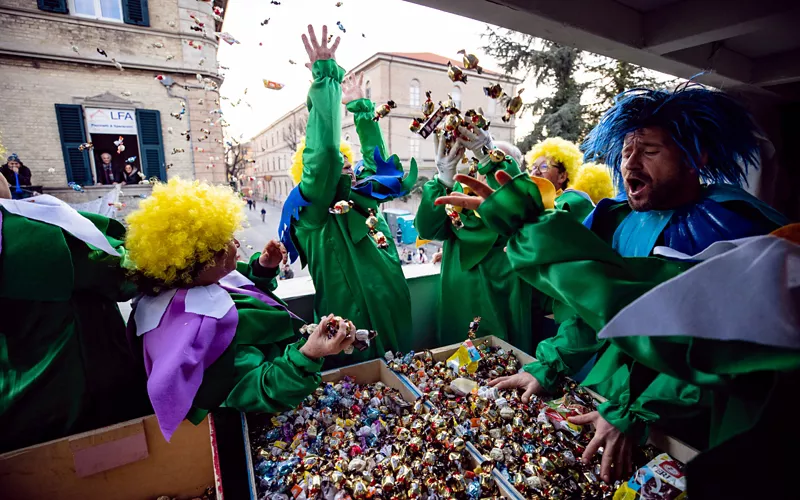 Throwing chocolates from allegorical floats