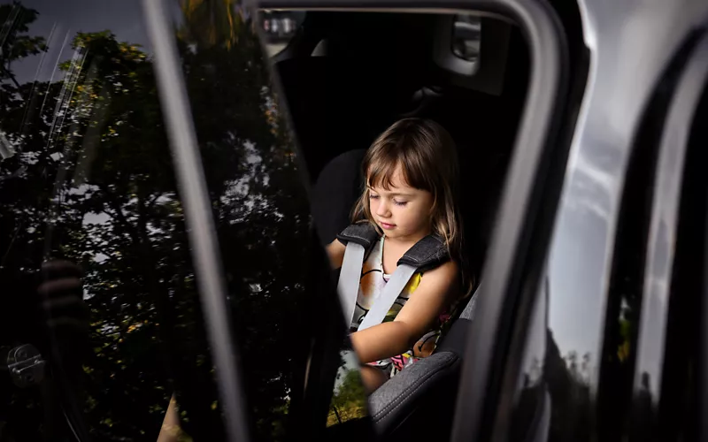 Child in the back seat of a car