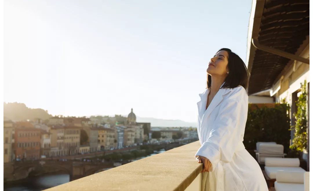 A woman looking out onto a balcony in Florence