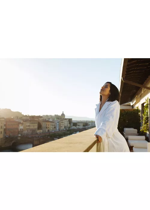 A woman looking out onto a balcony in Florence