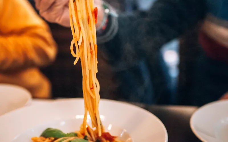 A dish of spaghetti with tomato sauce