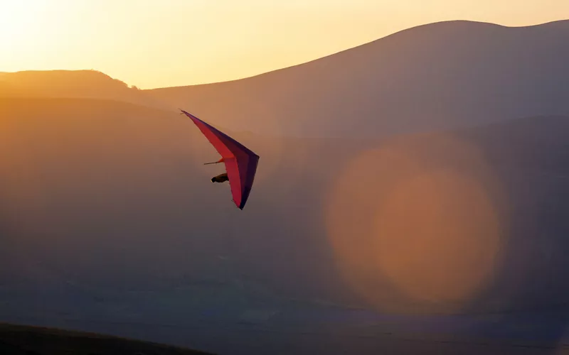 hang gliding at sunset