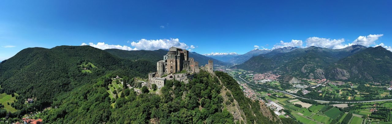 Sant'Ambrogio, Torino / Italy - 06/21/2020: The Sacra di San Michele (Saint Michael's) Abbey, Turin, Italy, shot aerial with mountains of Susa valley in background. Aerial view