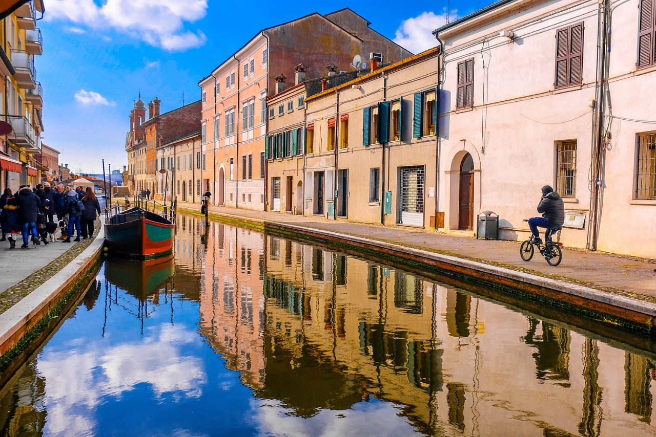 Comacchio vale - Ferrara province - Emilia Romagna region - cycling in Italy blue sky over canal .