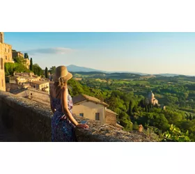 Montepulciano, Tuscany. Palazzo Comunale di Montepulciano Girl looks at the landscape of the city and countryside from the balcony