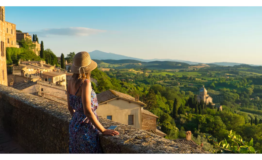 Montepulciano, Tuscany. Palazzo Comunale di Montepulciano Girl looks at the landscape of the city and countryside from the balcony