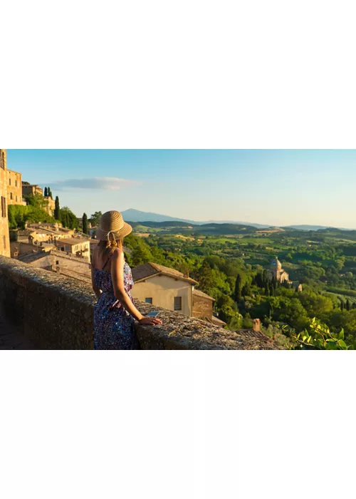 Montepulciano, Tuscany. Palazzo Comunale di Montepulciano Girl looks at the landscape of the city and countryside from the balcony