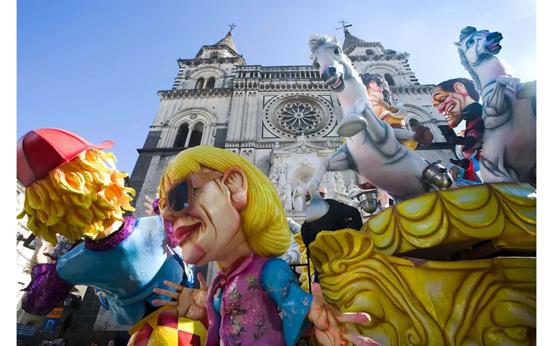 An allegorical float passing in front of Acireale Cathedral in Sicily during the Carnival