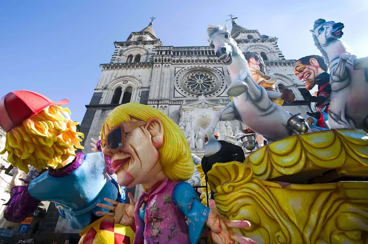 An allegorical float passing in front of Acireale Cathedral in Sicily during the Carnival