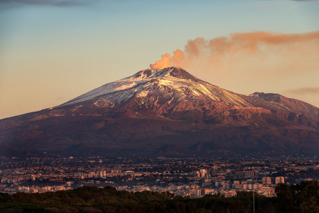 The mount Etna Volcano with smoke and the Catania city, Sicily island, Italy (Sicilia, Italia)