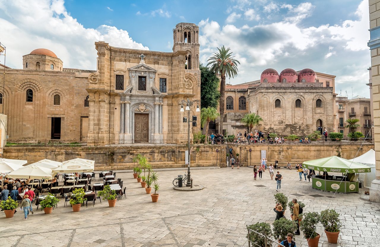 Palermo, Sicily, Italy - October 5, 2017: View of Bellini Square with tourists visiting the Santa Maria dell'Ammiraglio Church known as Martorana Church and San Cataldo church in the center of Palermo