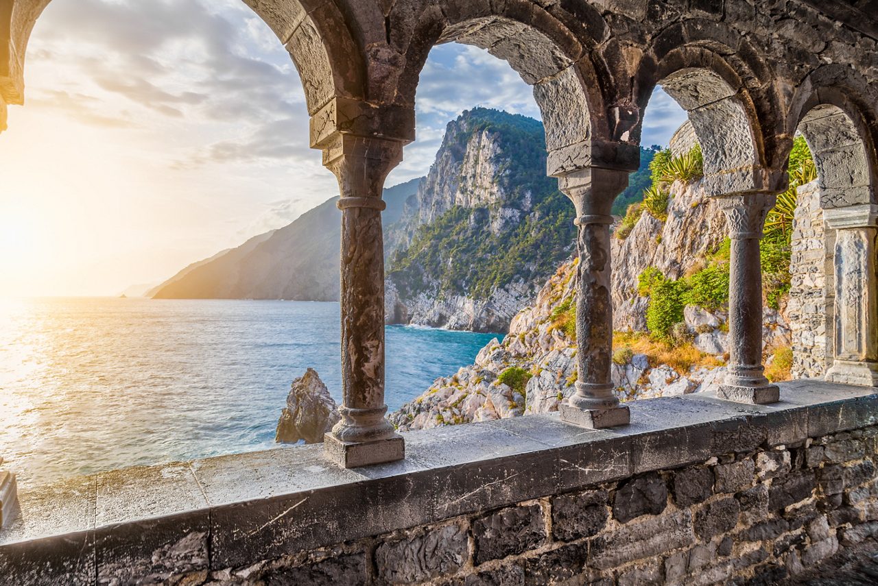 Columns of famous gothic Church of St. Peter (Chiesa di San Pietro) with beautiful shoreline scenery at sunset in the town of Porto Venere, Ligurian Coast, province of La Spezia, Italy.