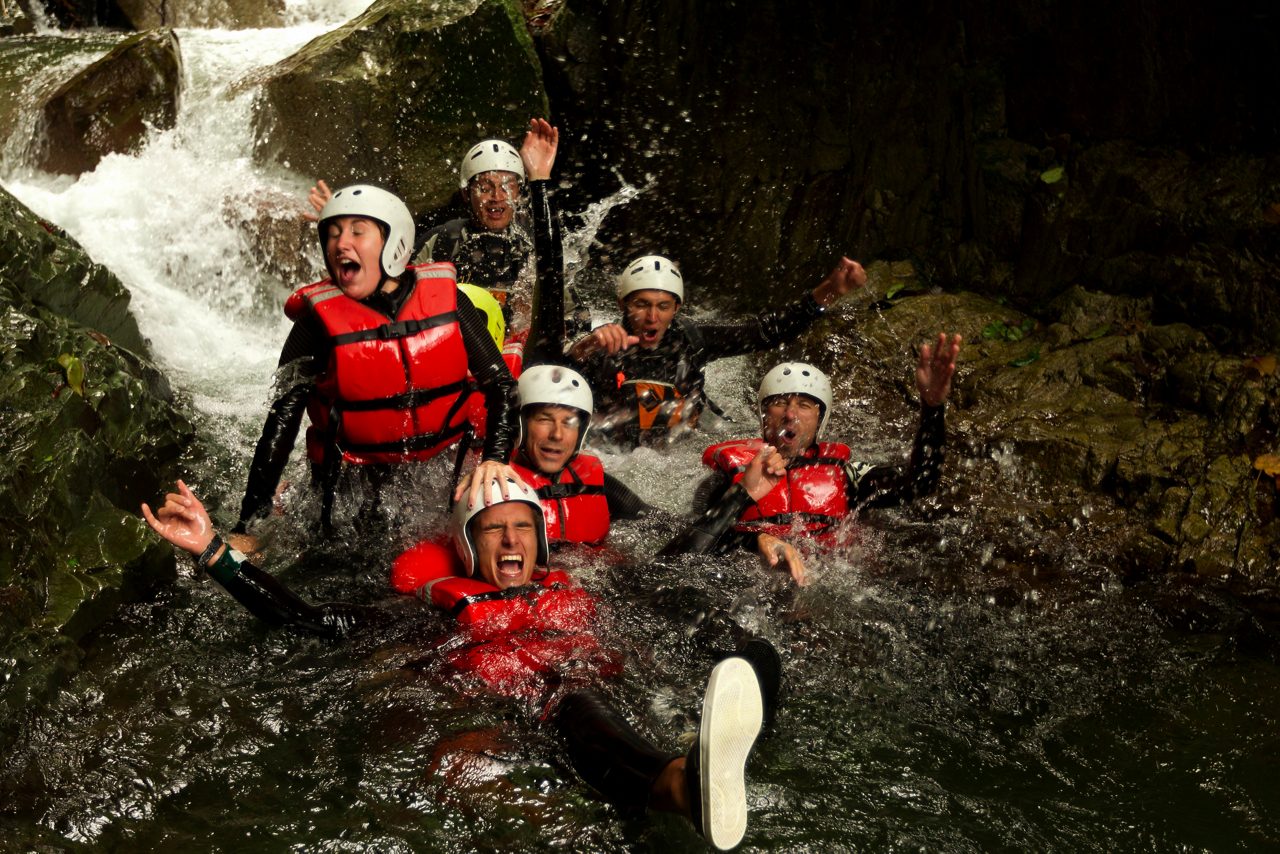 outdoor canyoning active group adventure water sport fun expedition river partnership of dynamic teen people during a canyoning expedition in ecuadorian rainforest outdoor canyoning active group adven