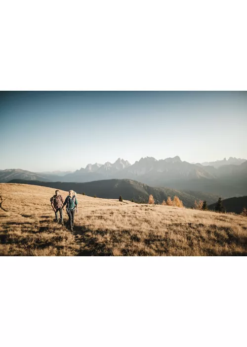 couple strolls in the dolomites