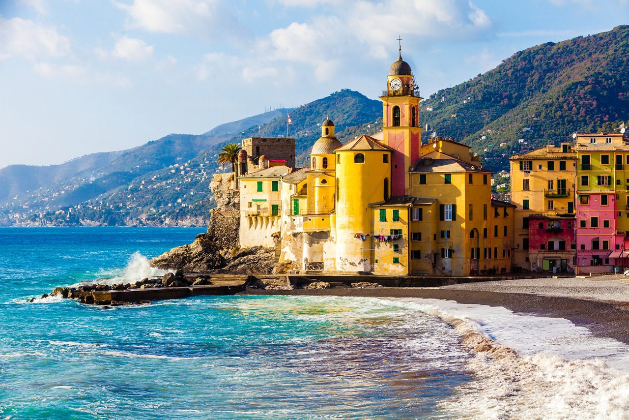 Scenic Mediterranean riviera coast. Panoramic view of Camogli town in Liguria, Italy. Basilica of Santa Maria Assunta and colorful palaces.