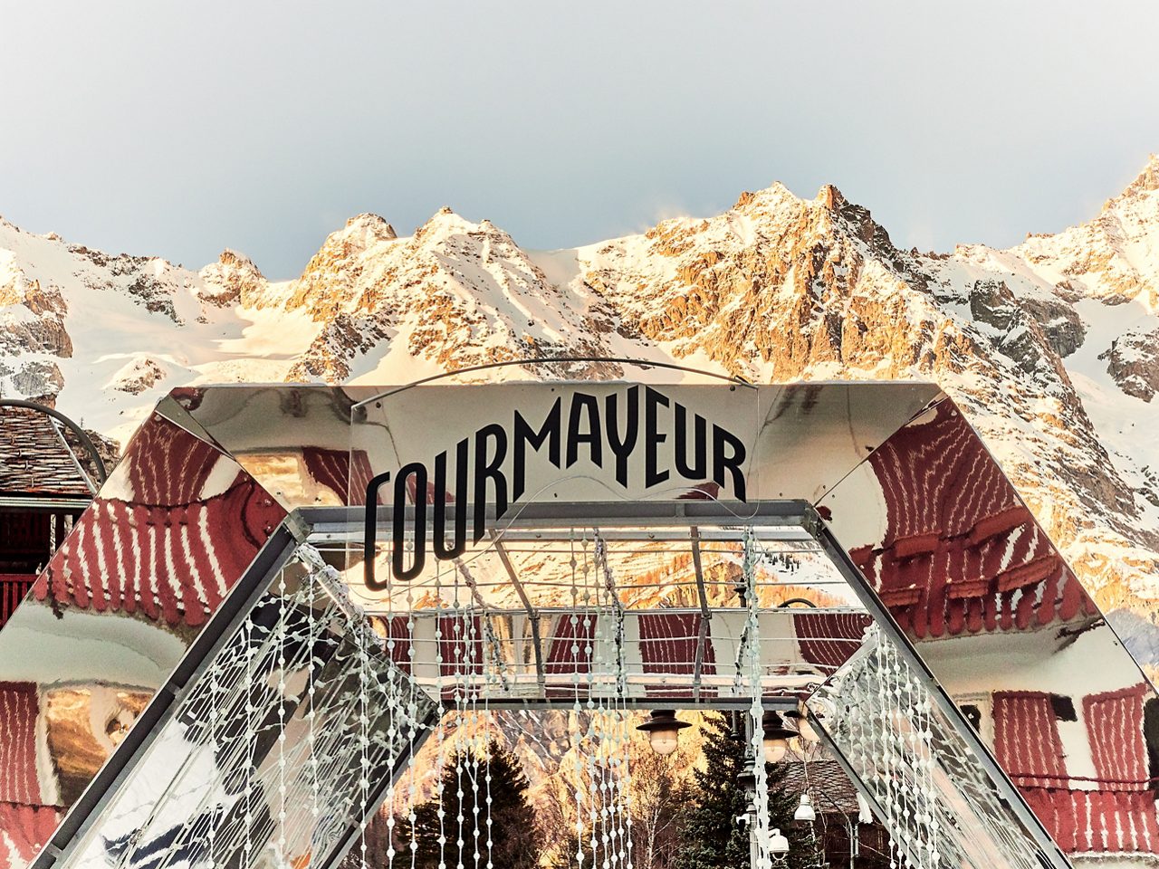 Courmayeur, Italy - January 18, 2020 Structure of mirrors in the square of Courmayeur indicating the arrival in the village with the background of the snowy mountains of the Aosta Valley in Italy