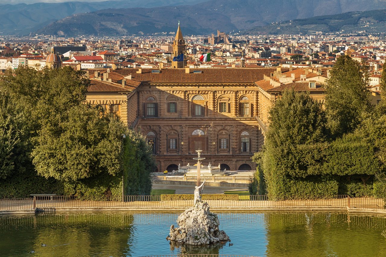 The Boboli Gardens park, Fountain of Neptune and a distant view on The Palazzo Pitti, in English sometimes called the Pitti Palace, in Florence, Italy. Popular tourist attraction and destination.