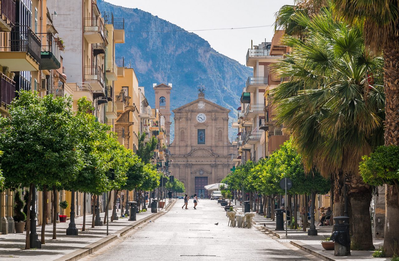 Corso Umberto I in Bagheria, with the Madrice Church in the background. Province of Palermo, Sicily, Italy.
