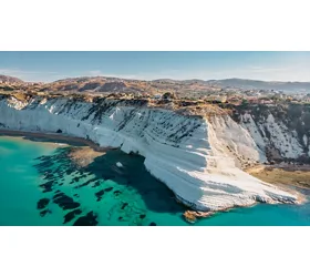 Aerial view of Scala dei Turchi white rocky cliff and of the turquoise sea below