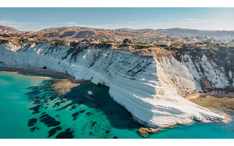 Aerial view of Scala dei Turchi white rocky cliff and of the turquoise sea below