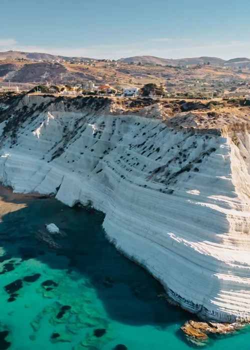 Aerial view of Scala dei Turchi white rocky cliff and of the turquoise sea below