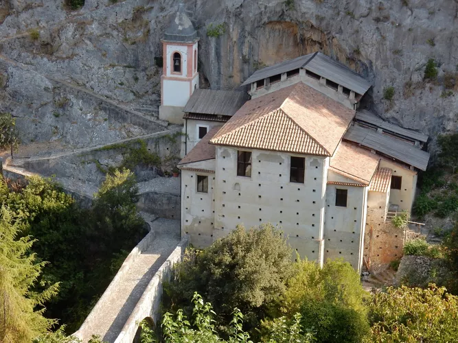 Aerial view of the Sanctuary of the Madonna del Pollino, built close to a majestic rock face