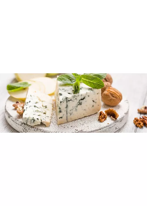 Segment of blue mould cheese - Gorgonzola with pear and walnuts on wooden board.  Top view